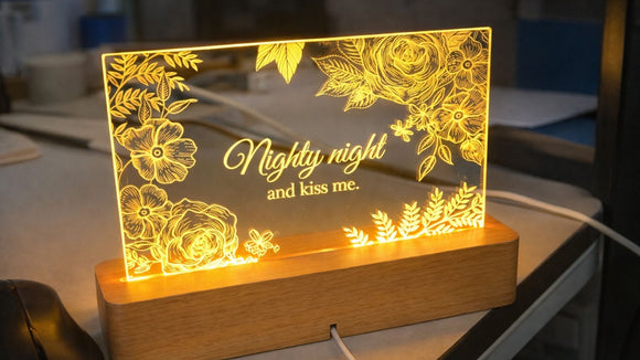 Laser engraved acrylic LED sign with floral engraving on clear acrylic, illuminated warm light acrylic engraving example